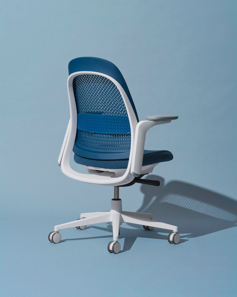 Rear view of a blue and white Haworth Breck chair showing the Geo Stretch geometric backrest pattern.