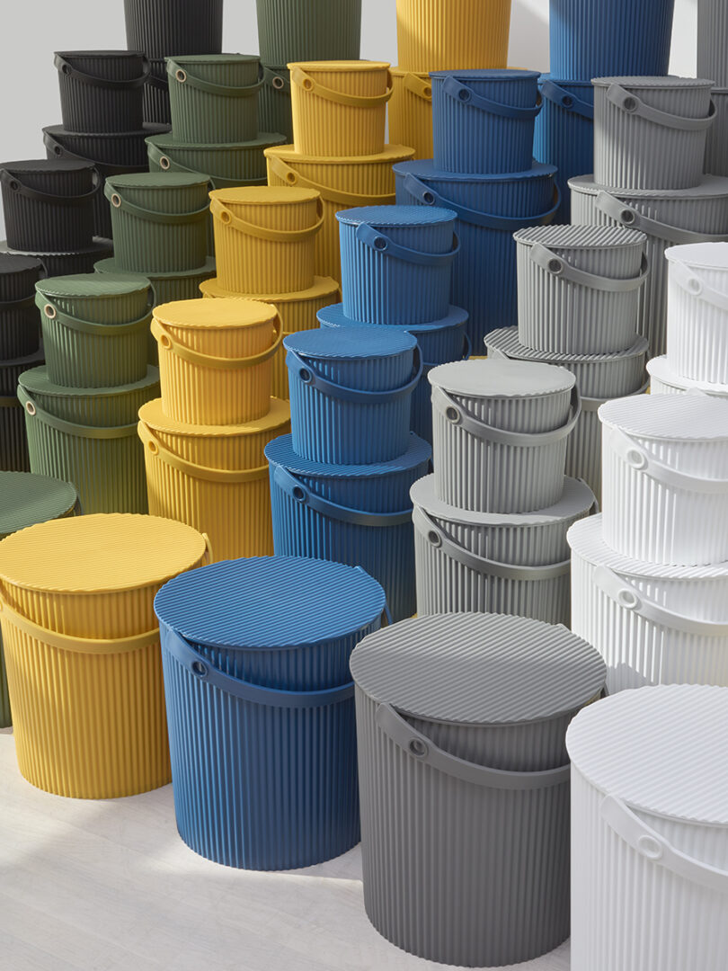 Rows of stacked Hachiman buckets in various colors showing their vertical storage efficiency.