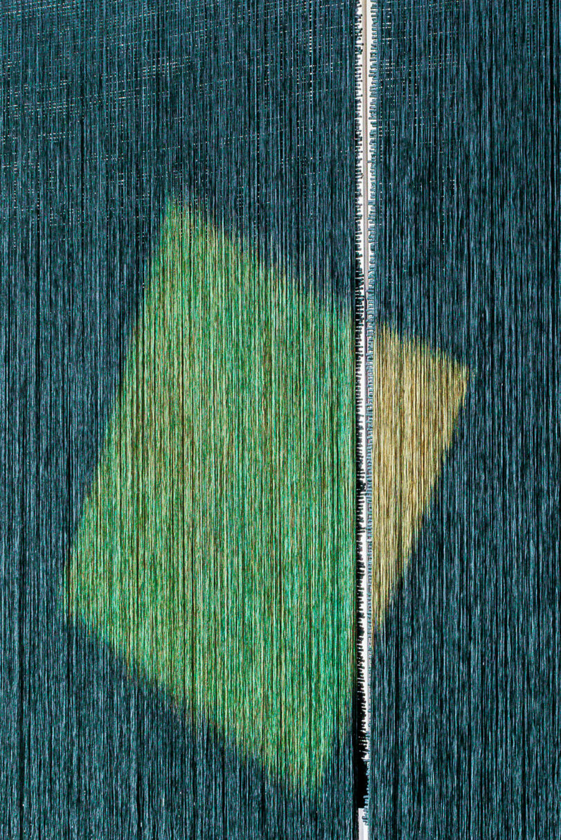 A close-up of a traditional weaving loom with a geometric pattern in progress.