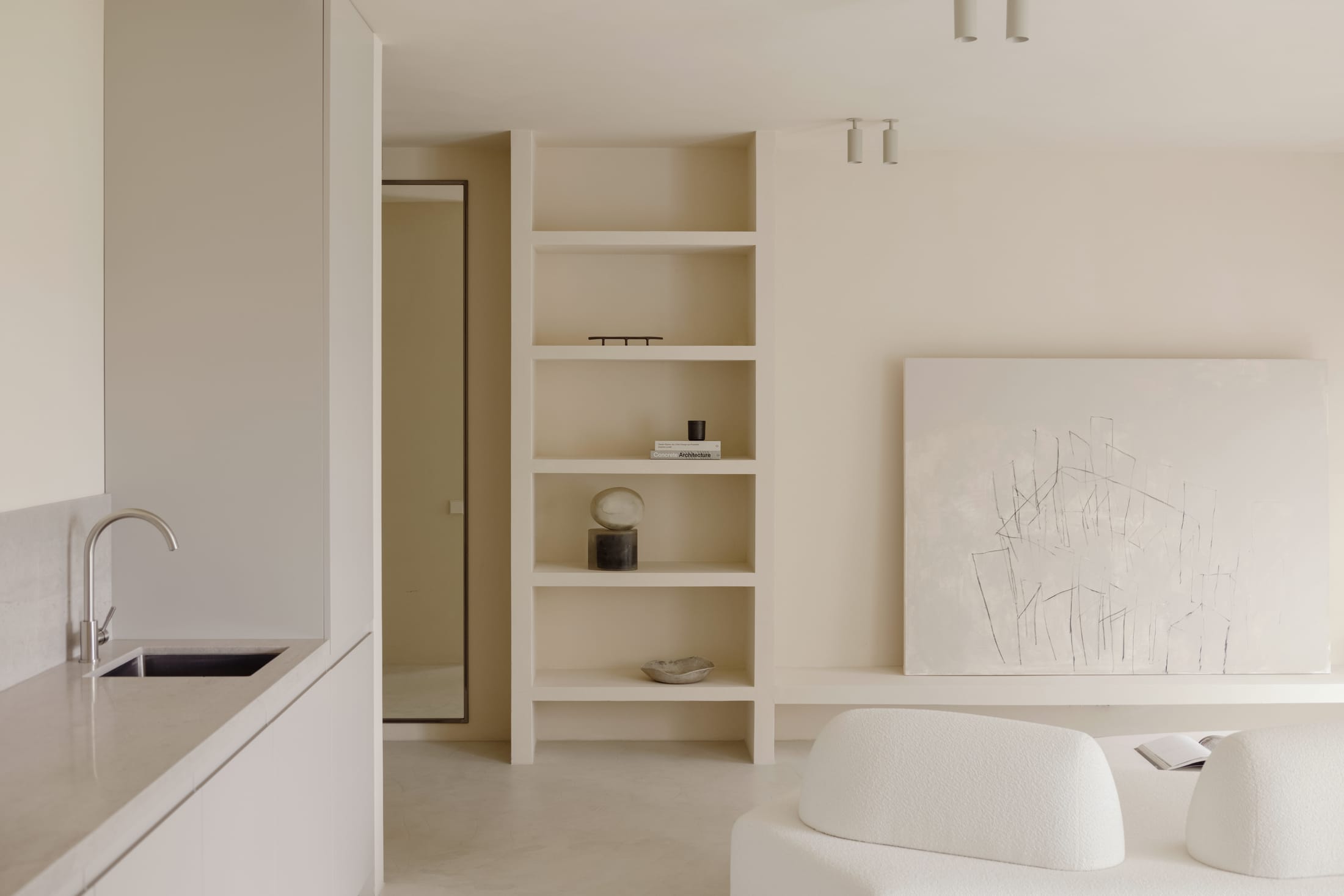 A soft rug defining the lounge area within the open-plan layout of Blondie Space.