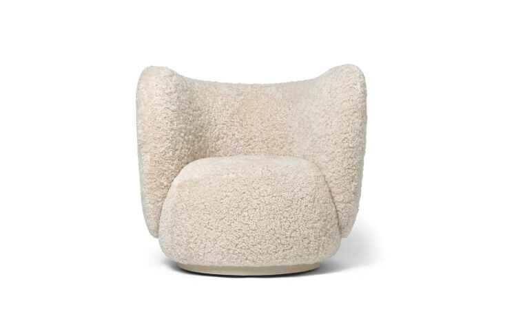Ferm Living Rico Lounge Chair in moonlight sheepskin with a modern, heavy rounded base.