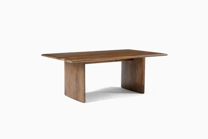 Modern wood coffee table with chunky legs and a warm finish.