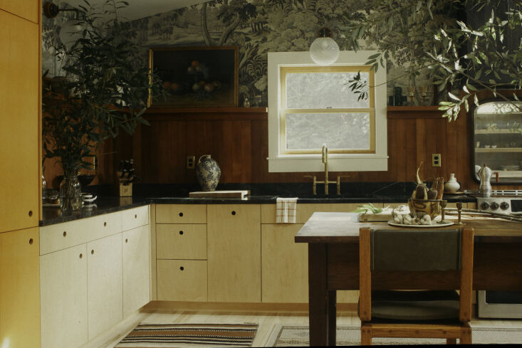 Detail of House of Hackney's Plantasia wallpaper used in a kitchen setting with antique elements.