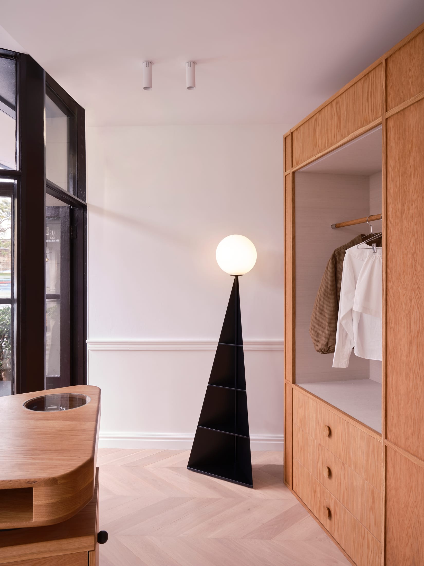 A sculptural timber-clad fitting room volume situated in the center of the retail space.