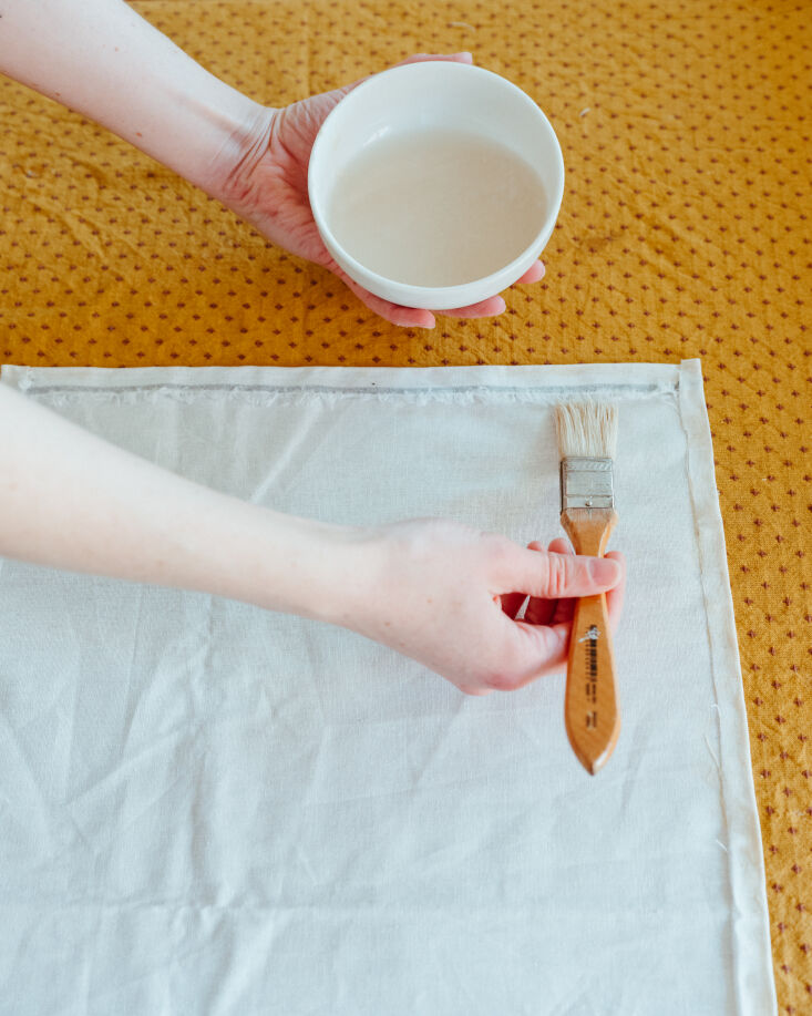 Applying laundry starch to white fabric for extra stiffness.