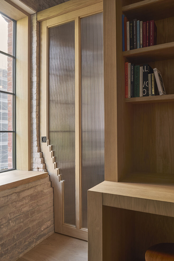A custom wooden door frame designed to interlock perfectly with the stepped profile of an old masonry wall.