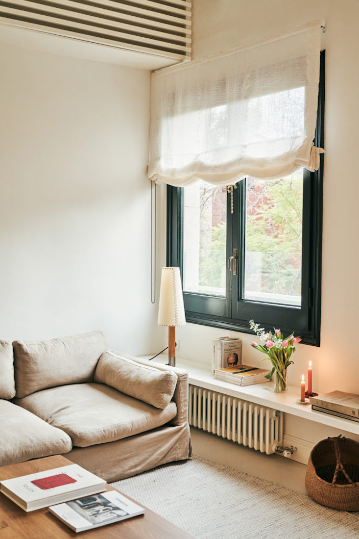 A Básica lamp in a quiet reading corner with soft lighting.