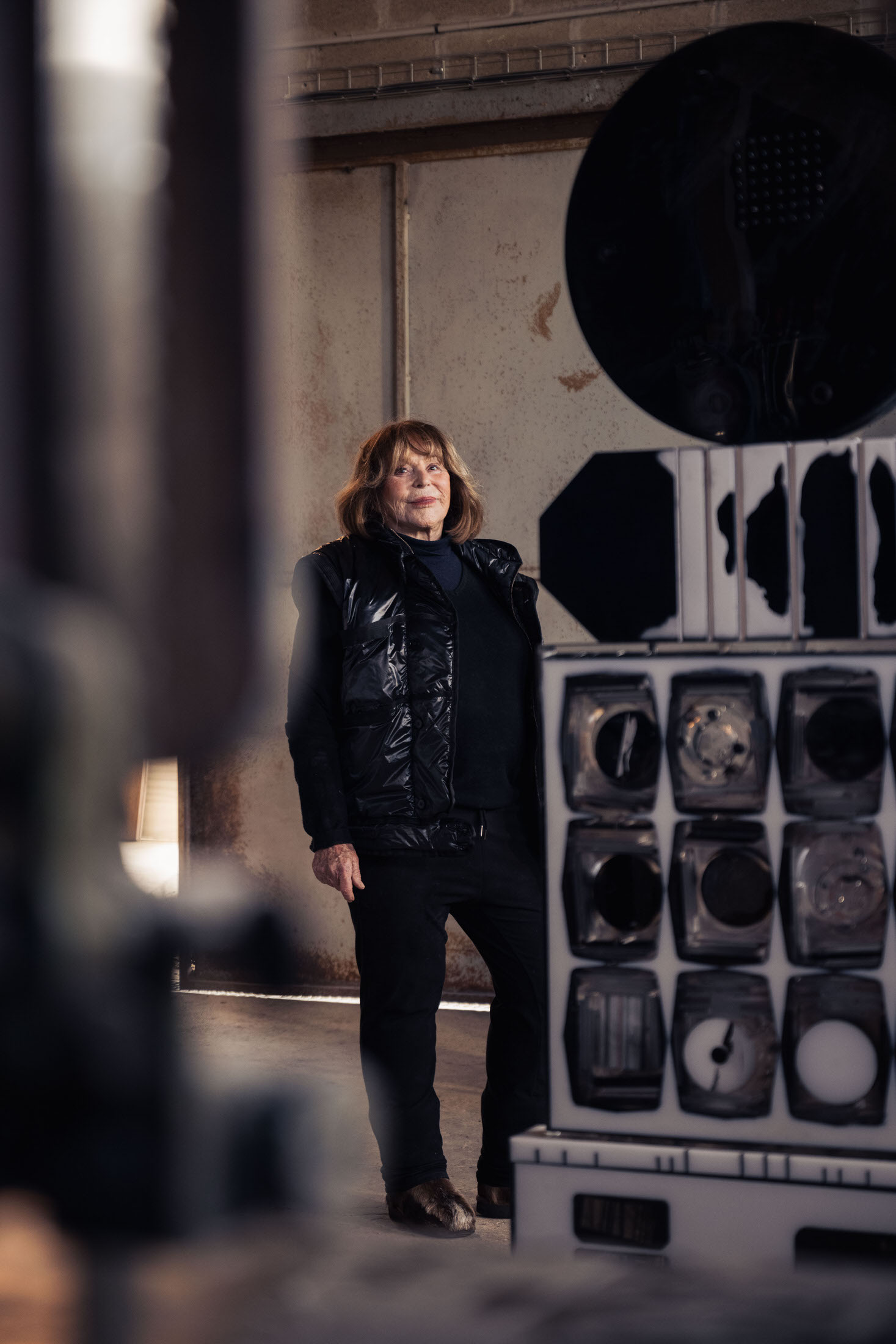 Portrait of artist Monique Rozanès in her studio surrounded by her resin sculptures.