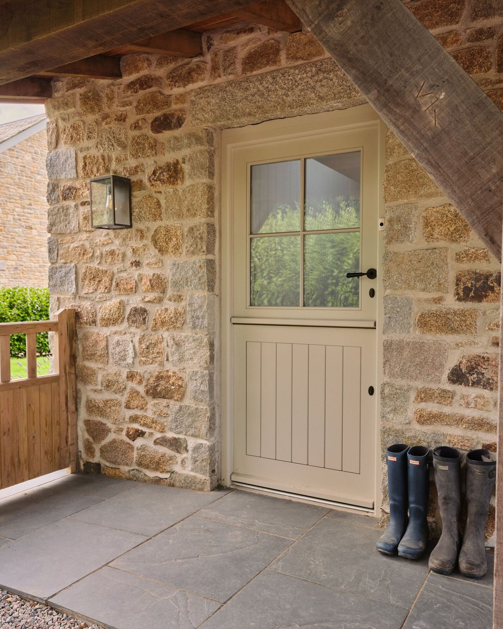 Entrance of a house with Cornish granite steps, a slate walkway, and a traditional black Dutch door.