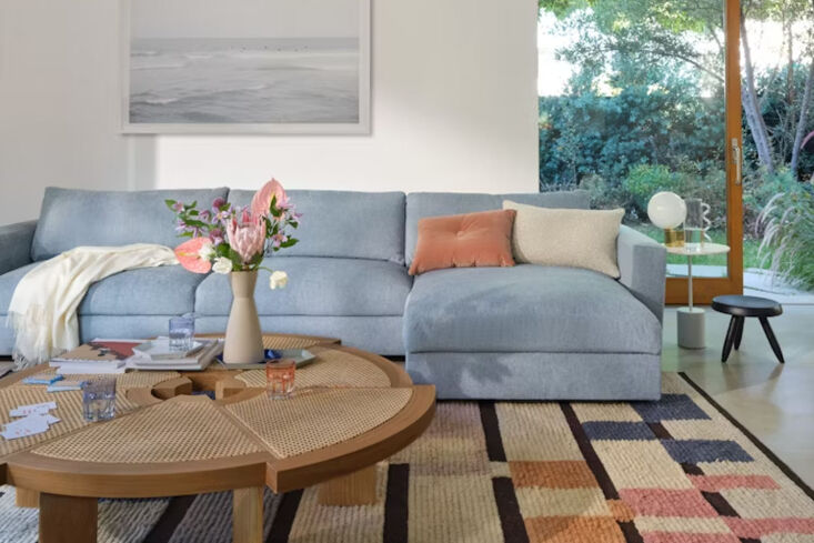 The Reid Sleeper Sectional by Design Within Reach showing the back folded down and the chaise storage open.