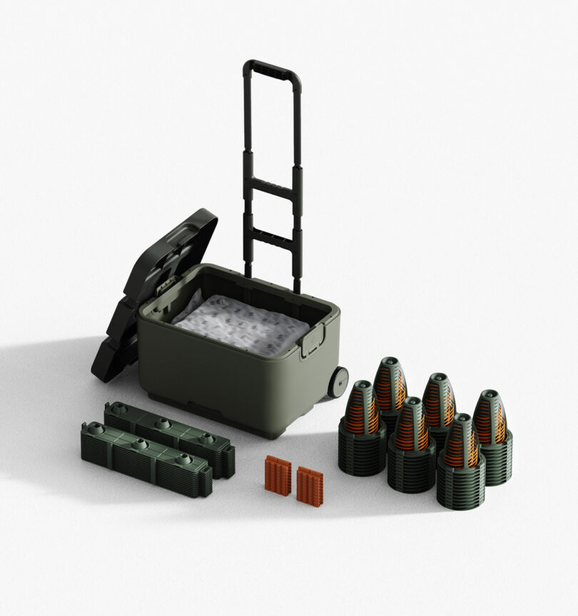 The modular components of the mattress stacked next to a green rolling storage container.