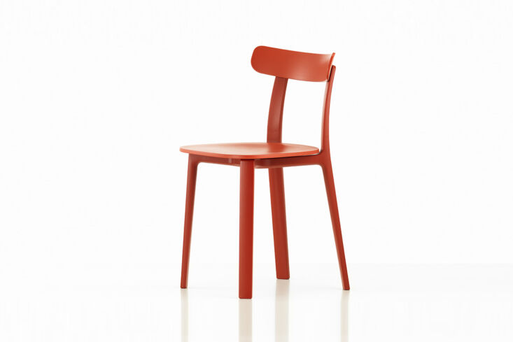 Side view of the Vitra All Plastic Chair in a matte brick red finish.