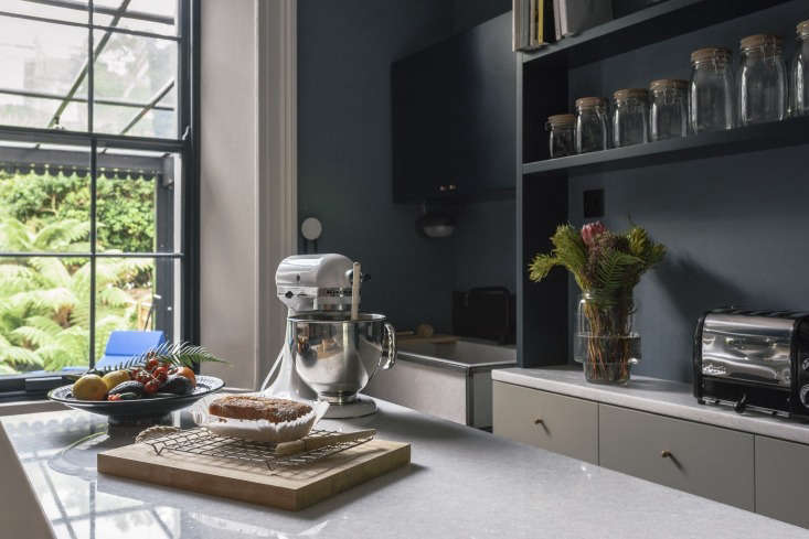 A KitchenAid stand mixer sits on the white marble surface of the kitchen island.