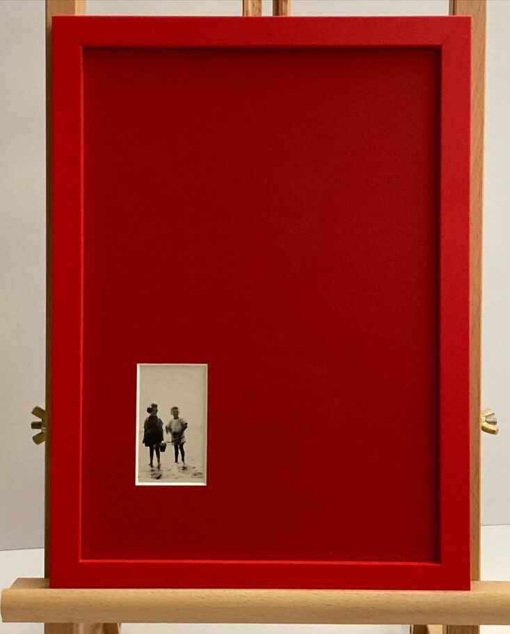 A vibrant yellow picture frame providing a bold pop of color against a gallery wall.
