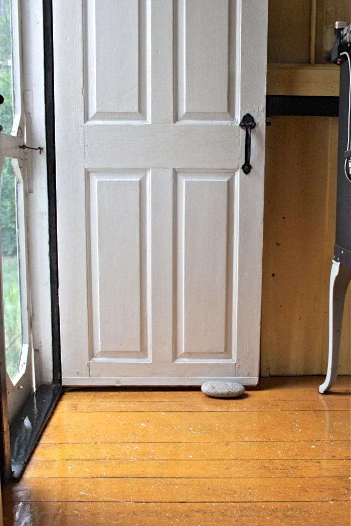 A kitchen floor with a bright pumpkin orange base coat and white and black spatters.