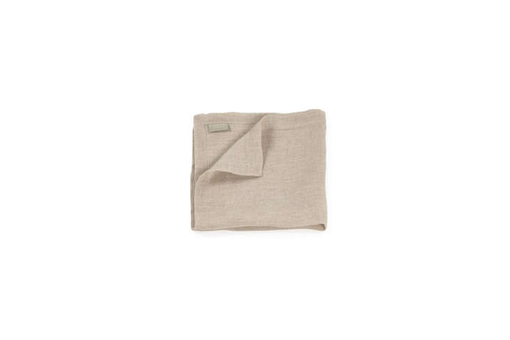 Folded linen napkins with a subtle striped texture.