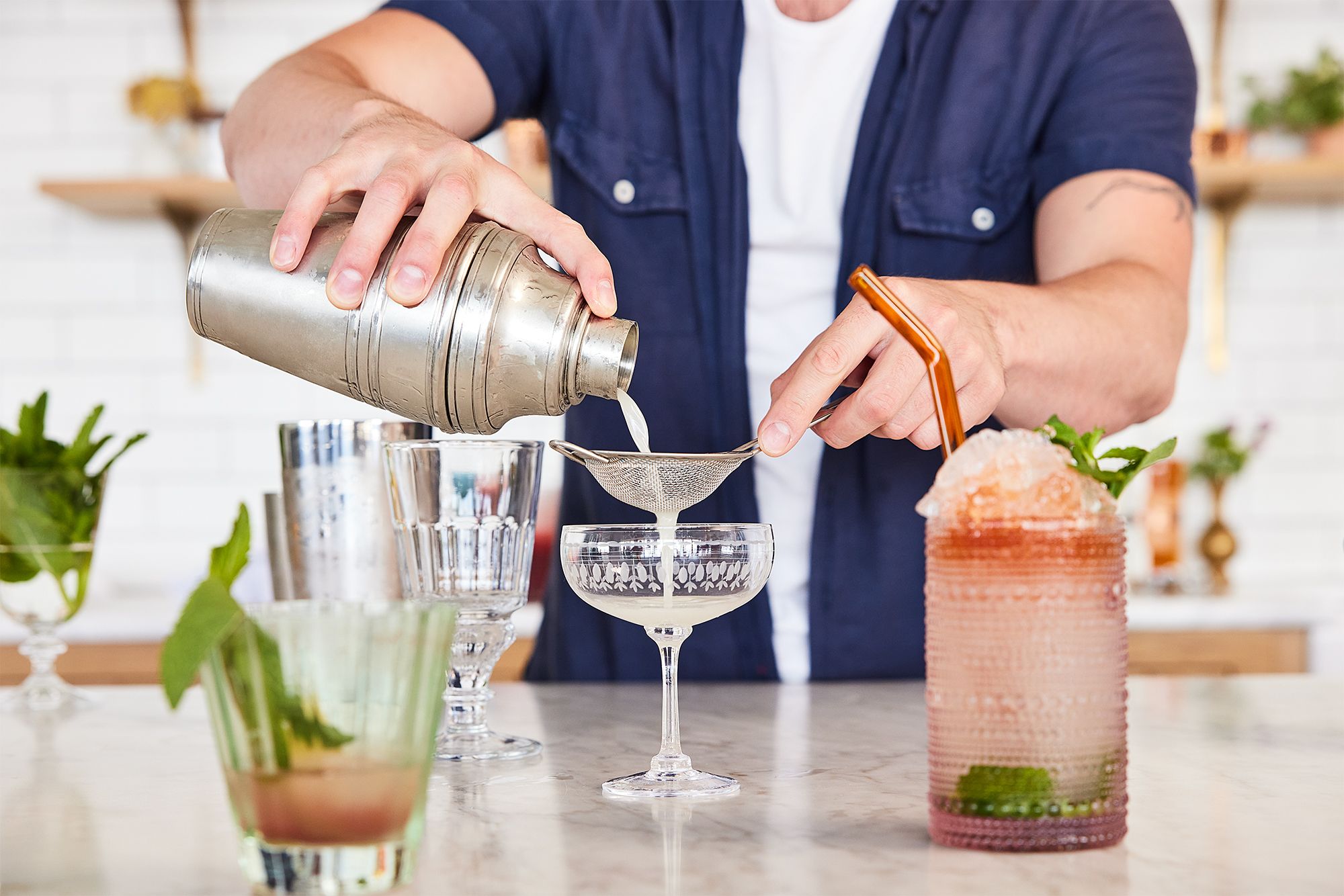A collection of high-end bar tools and cocktail ingredients arranged aesthetically.