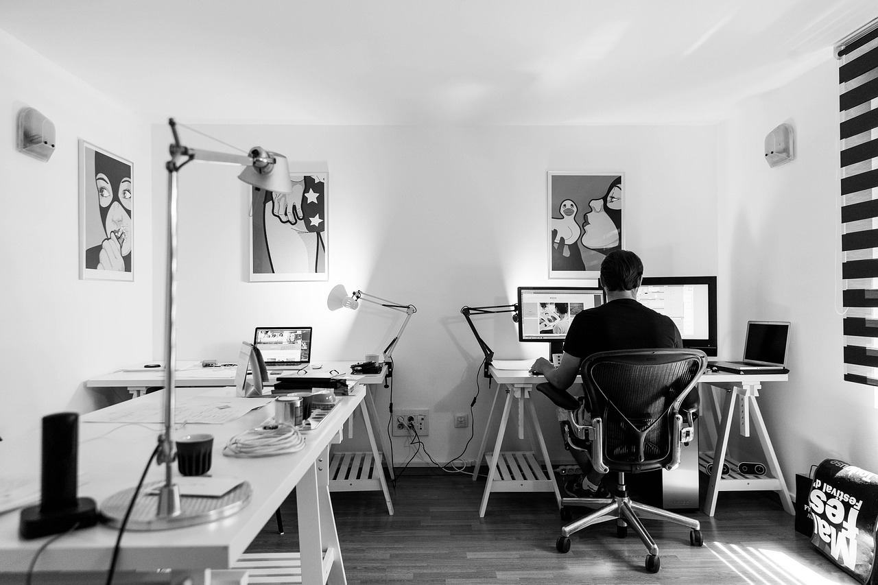 Close up of person browsing furniture on a laptop screen