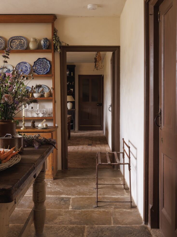 A wooden door painted in a deep charcoal gray shade titled 'Scullery' by Little Greene.