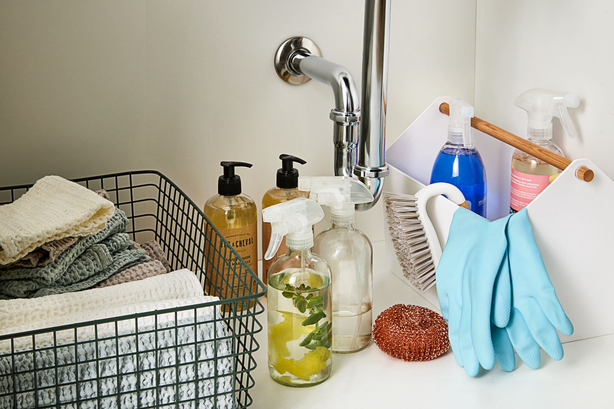 Text overlay reading 'Wait, Do Household Cleaning Products & Disinfectants Expire?' on a background of various cleaning supply containers.