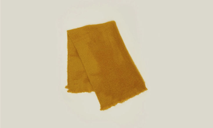 A mustard-colored mohair throw blanket with a rich, fuzzy texture.