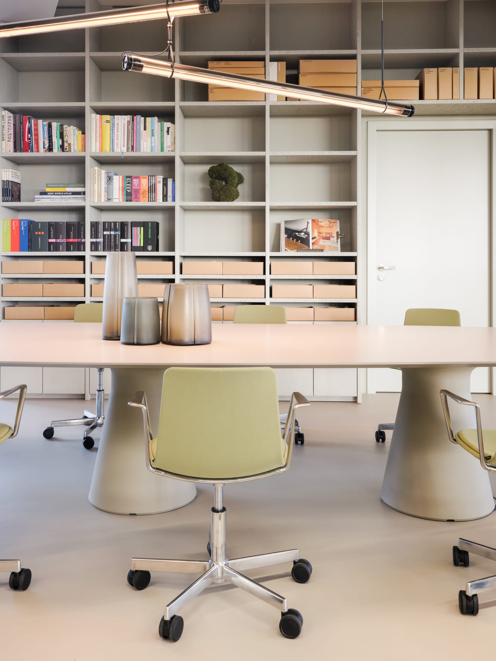 Minimalist workstations with modern chairs and integrated technology for hybrid work.