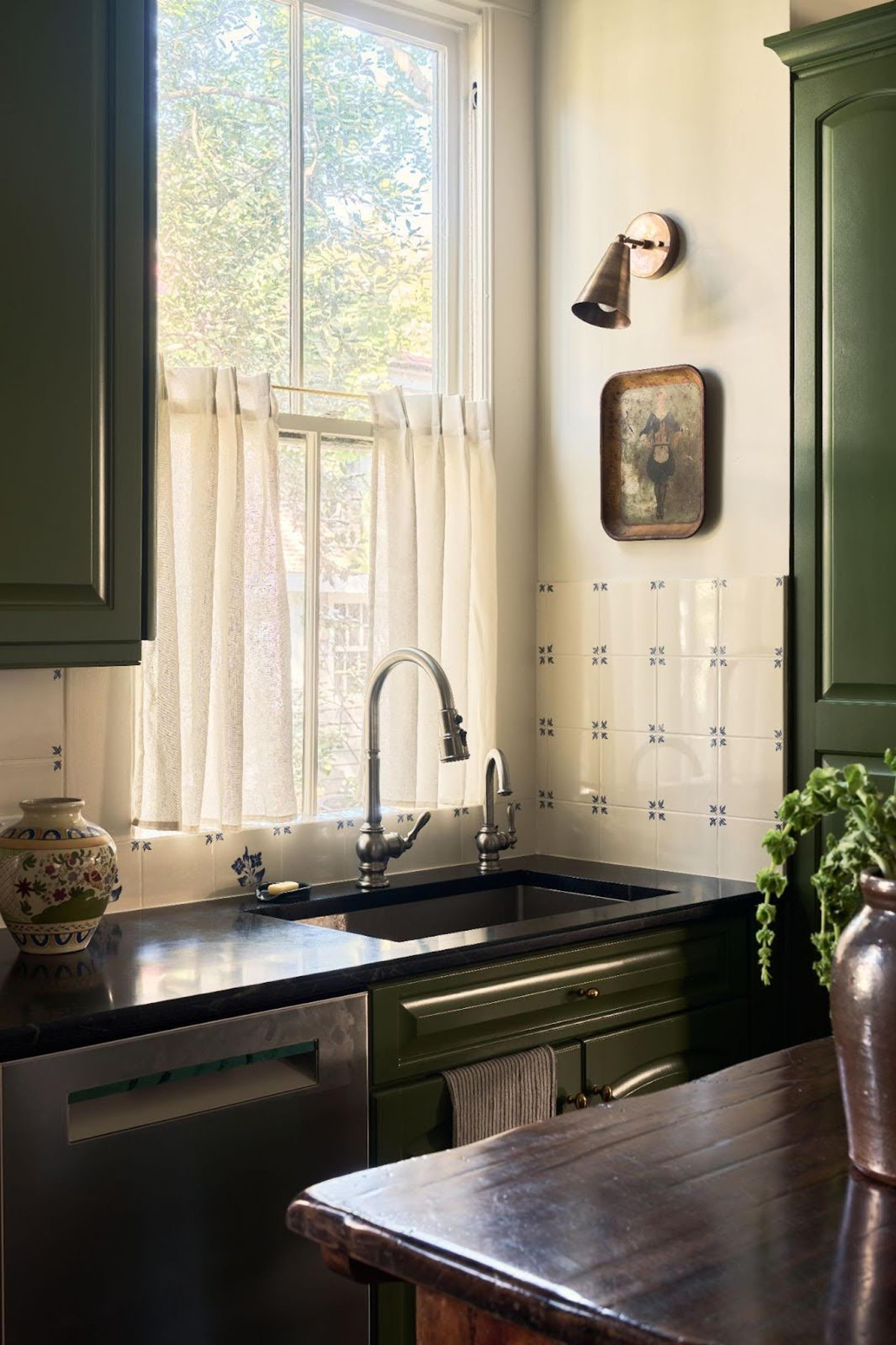 A detailed view of a modern kitchen sink area with new tiling.