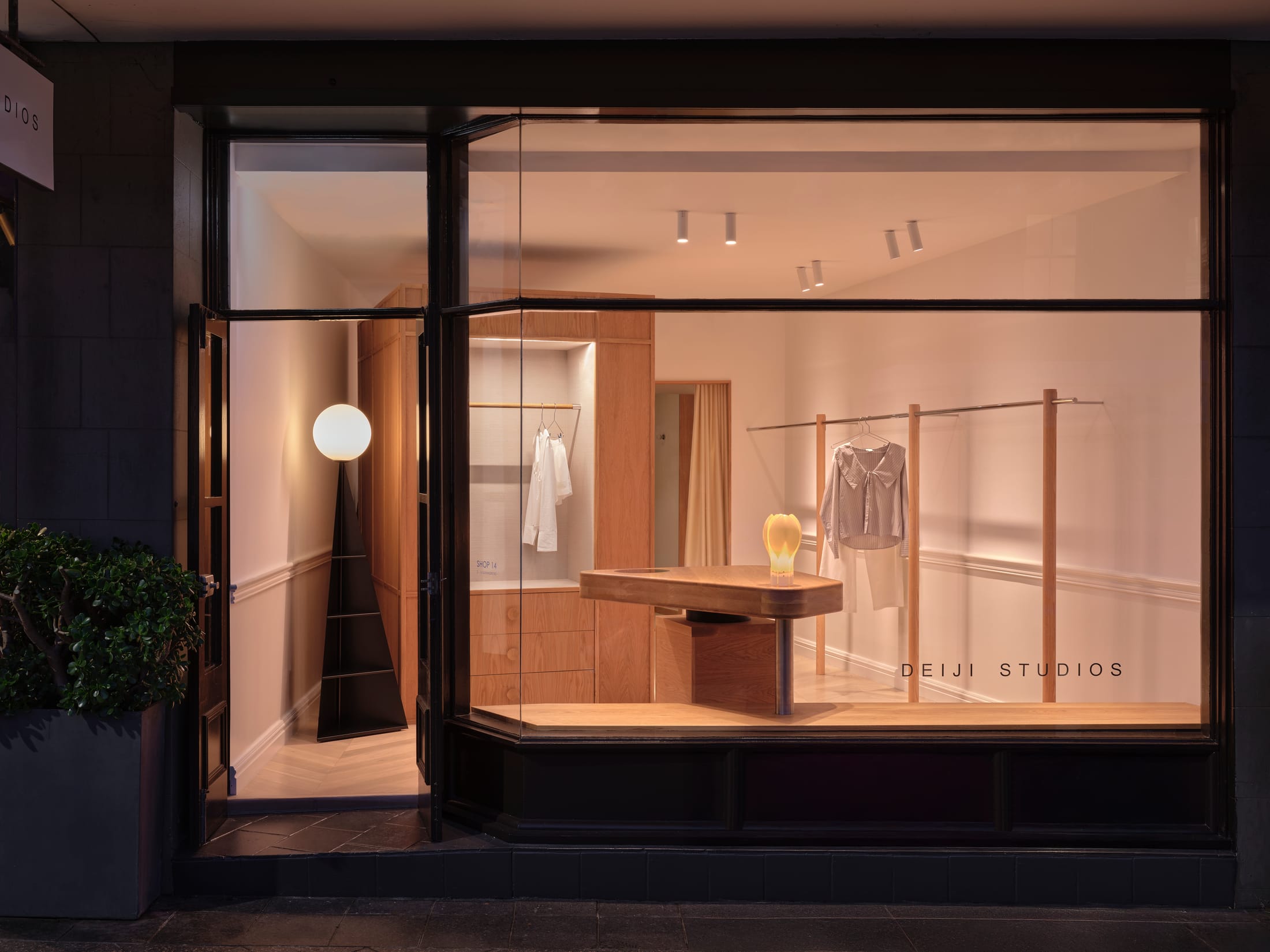 Faceted full-length mirrors at the rear of the store creating an illusion of expanded space.