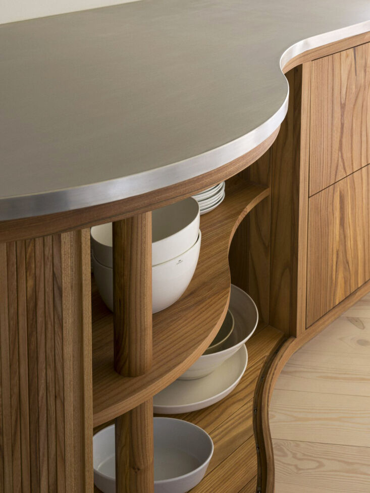 Detail of rounded, organic corners on a custom wood kitchen island.