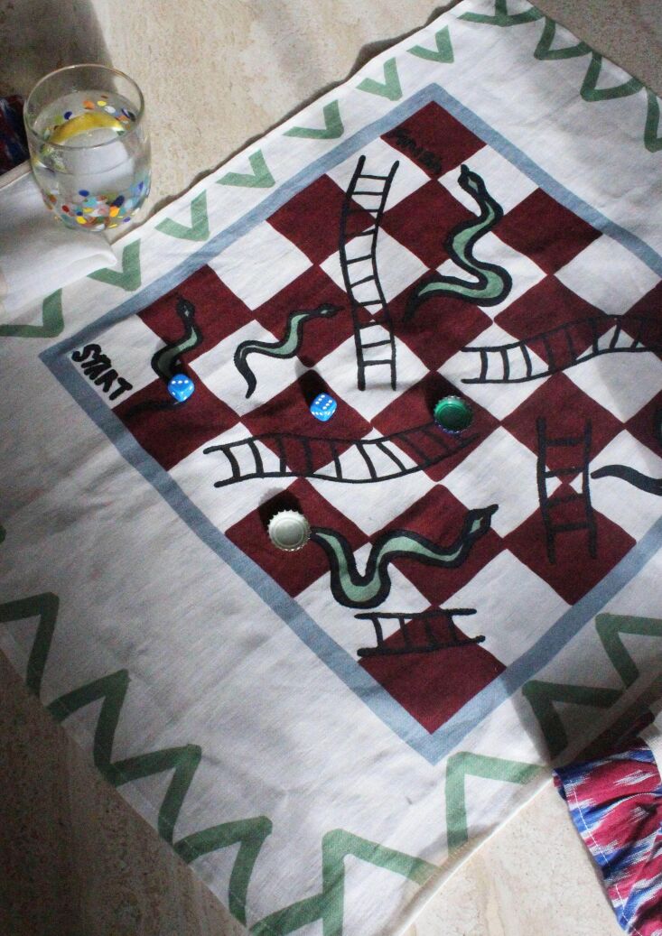 A colorful Snakes and Ladders tea towel design.