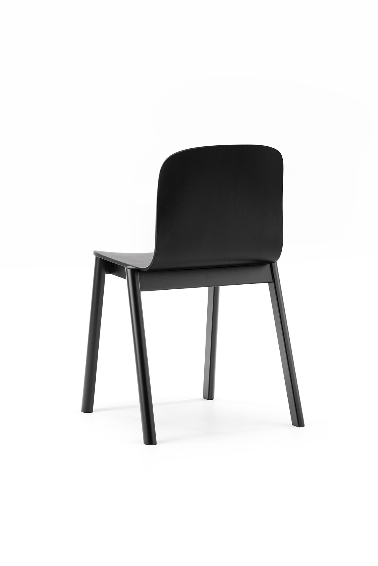 A minimalist black wooden chair designed by Alexander Gufler.