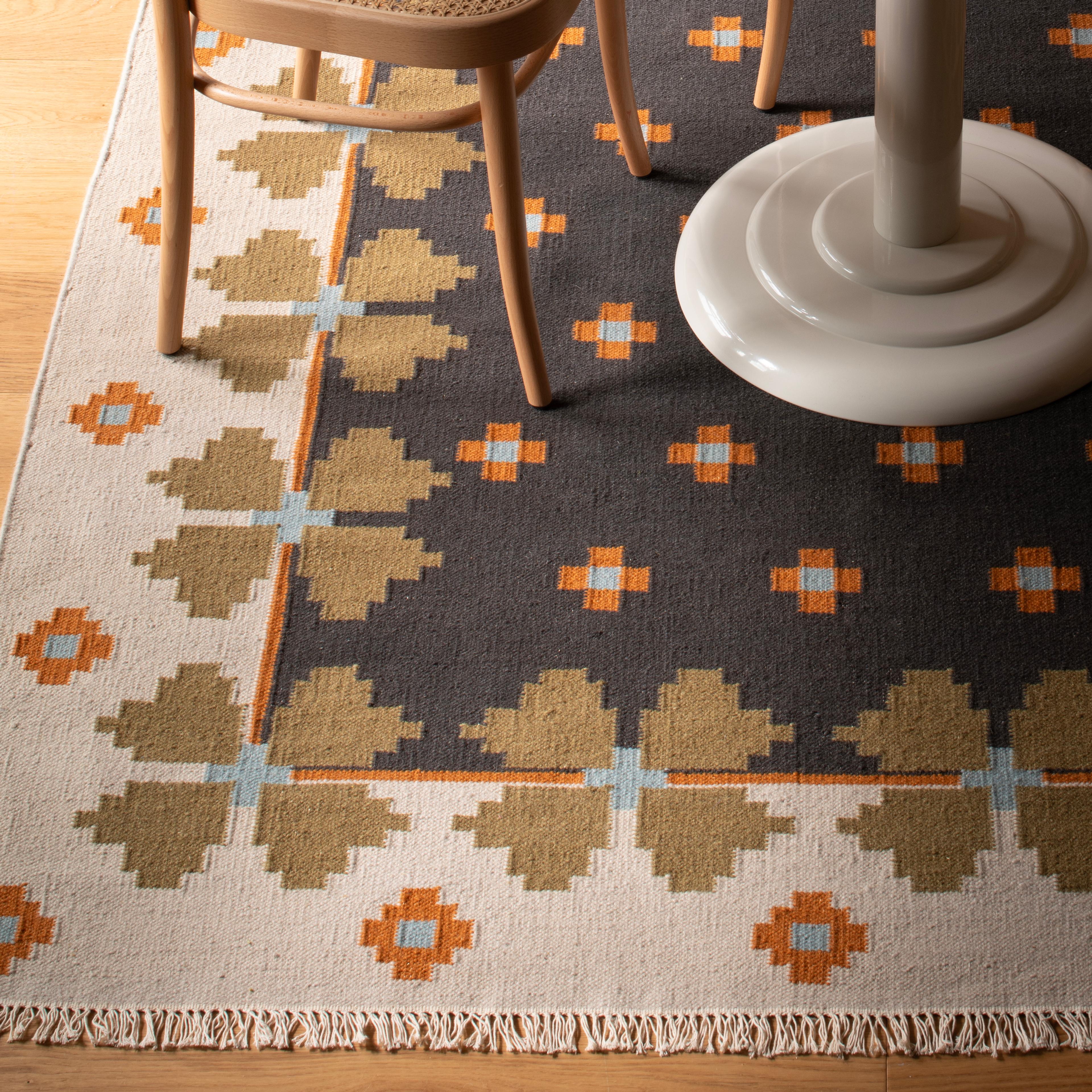 A charcoal-colored flora patterned rug.