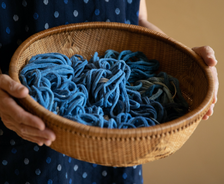 A small hand-weaving loom with colorful fabric loops ready for crafting.