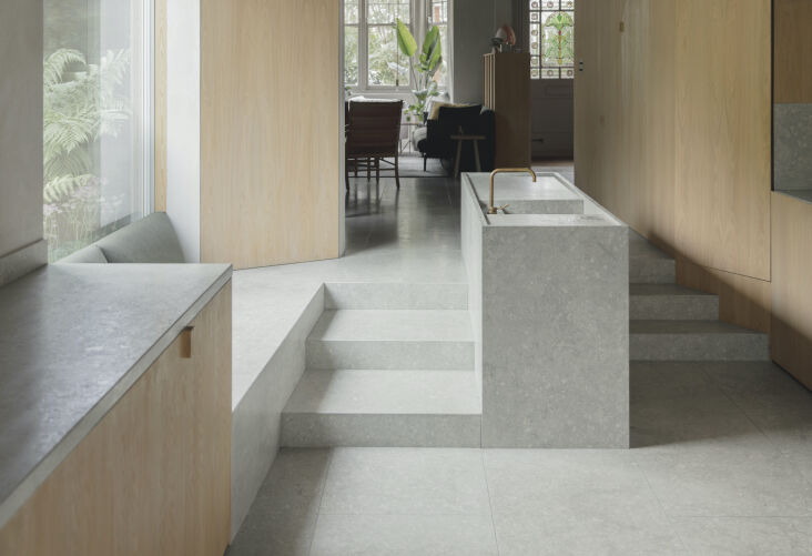 Interior view featuring the combination of natural oak, lime plaster, and limestone flooring.