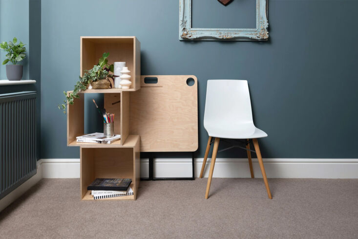 A plywood desk designed to be easily disassembled and stored flat.