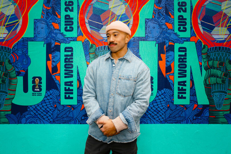 Rich Tu standing in front of a colorful FIFA World Cup 26 mural.