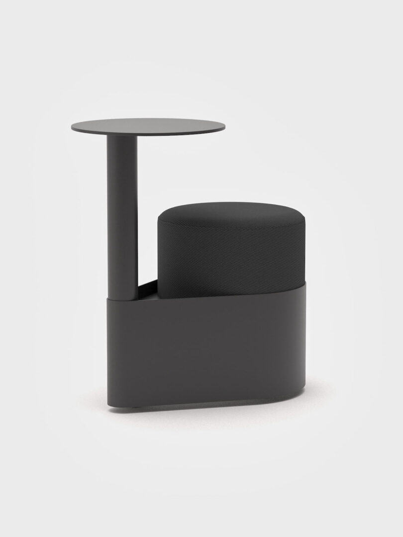 A black minimalist pony chair with an integrated circular table on a pedestal base.