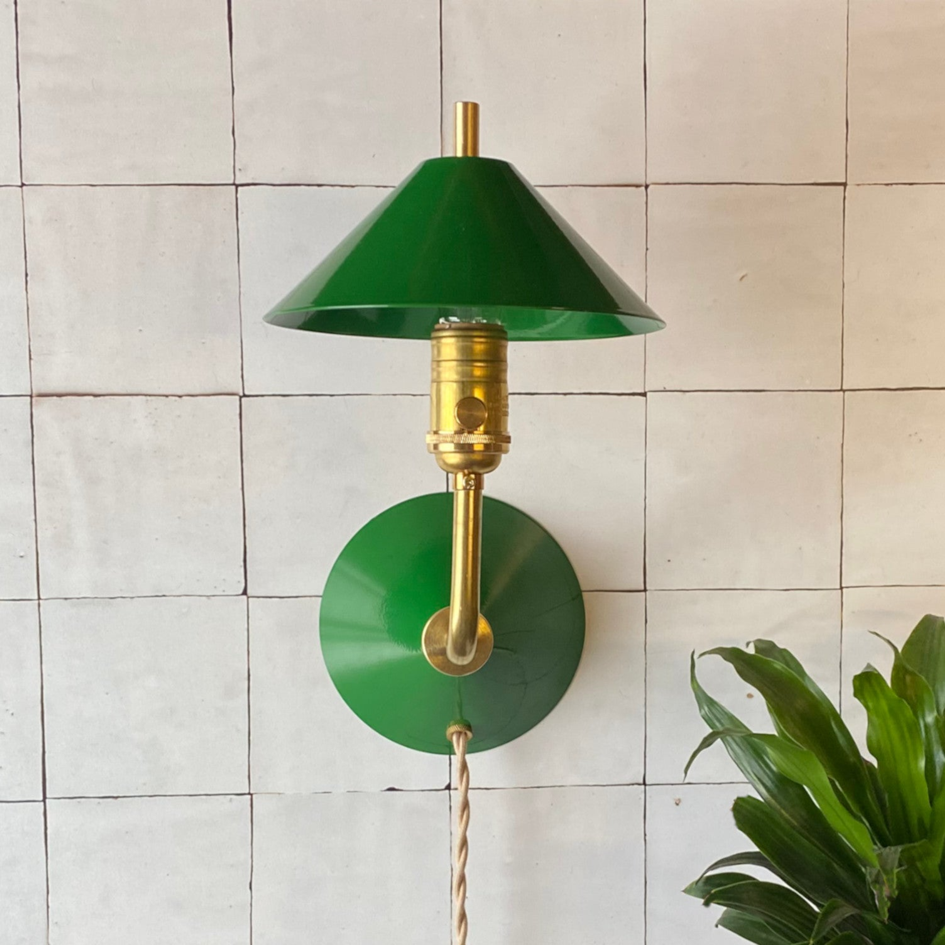 A minimalist Matt Alford Studio Bungalow sconce mounted on a neutral wall.