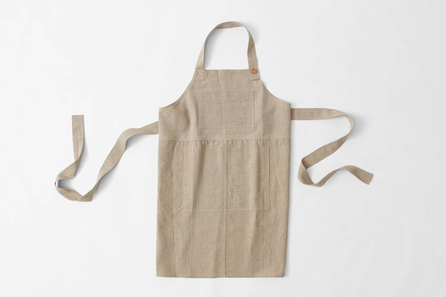 A sturdy, dark-toned utility apron with reinforced stitching and multiple tool pockets.