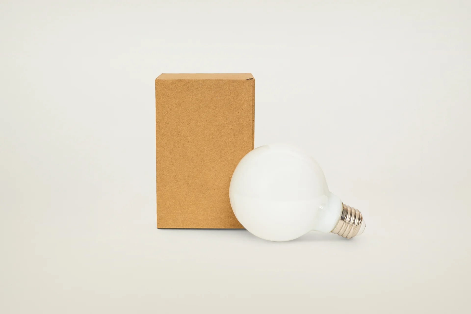 Two Ravenhill Studio G25 LED bulbs, one standard and one Dim-to-Warm variant.