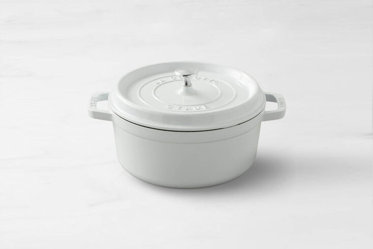 A deep blue Staub Enameled Cast Iron Round Dutch Oven.