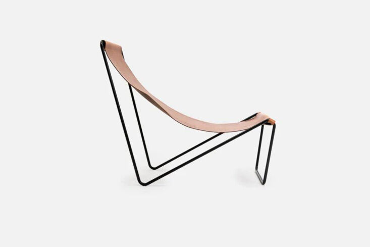 A minimalist Michael Verheyden G55 Sling Chair with a thin black wire frame and hand-stitched leather.