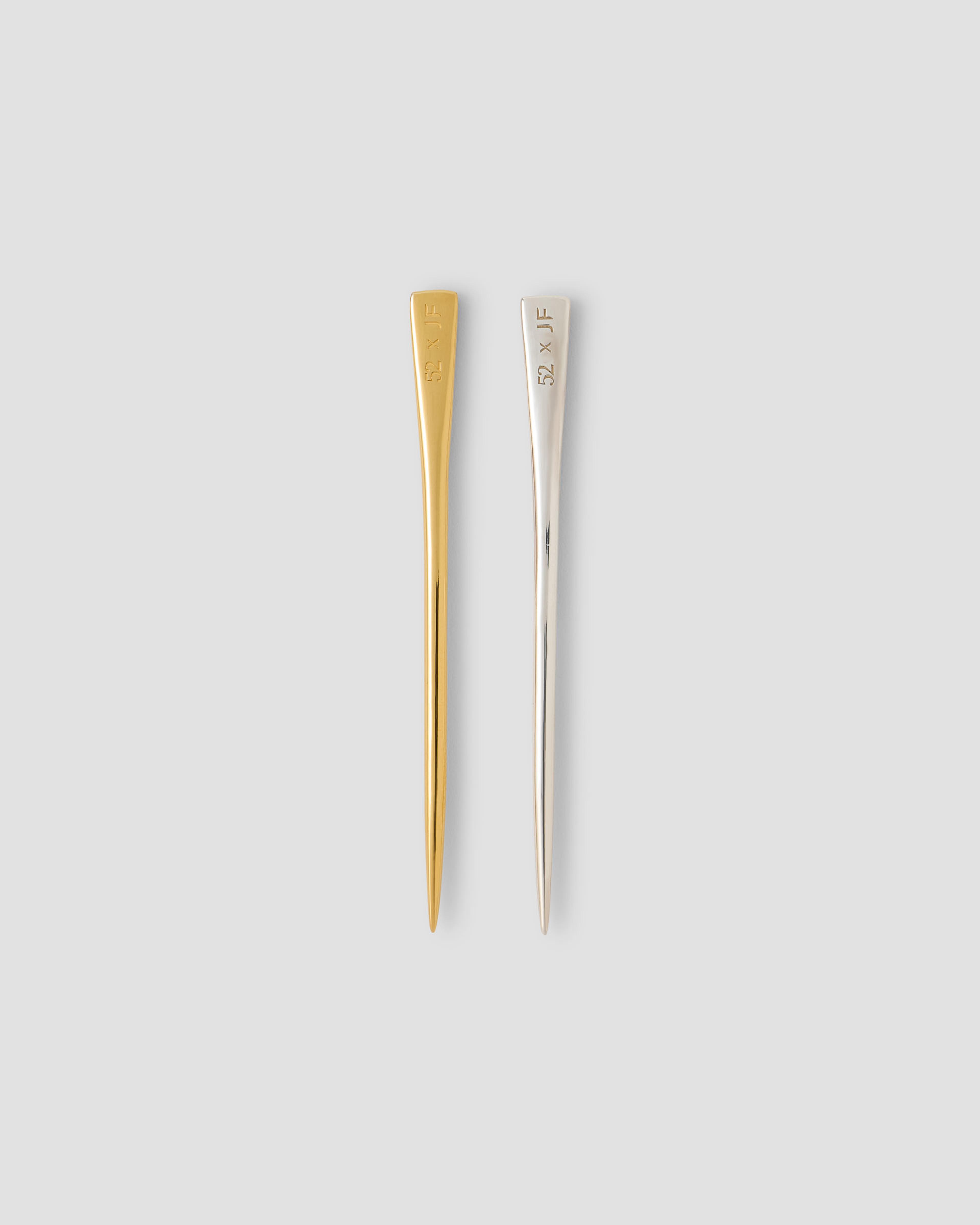 A comparison shot of the sterling silver and 14k yellow gold toothpicks.