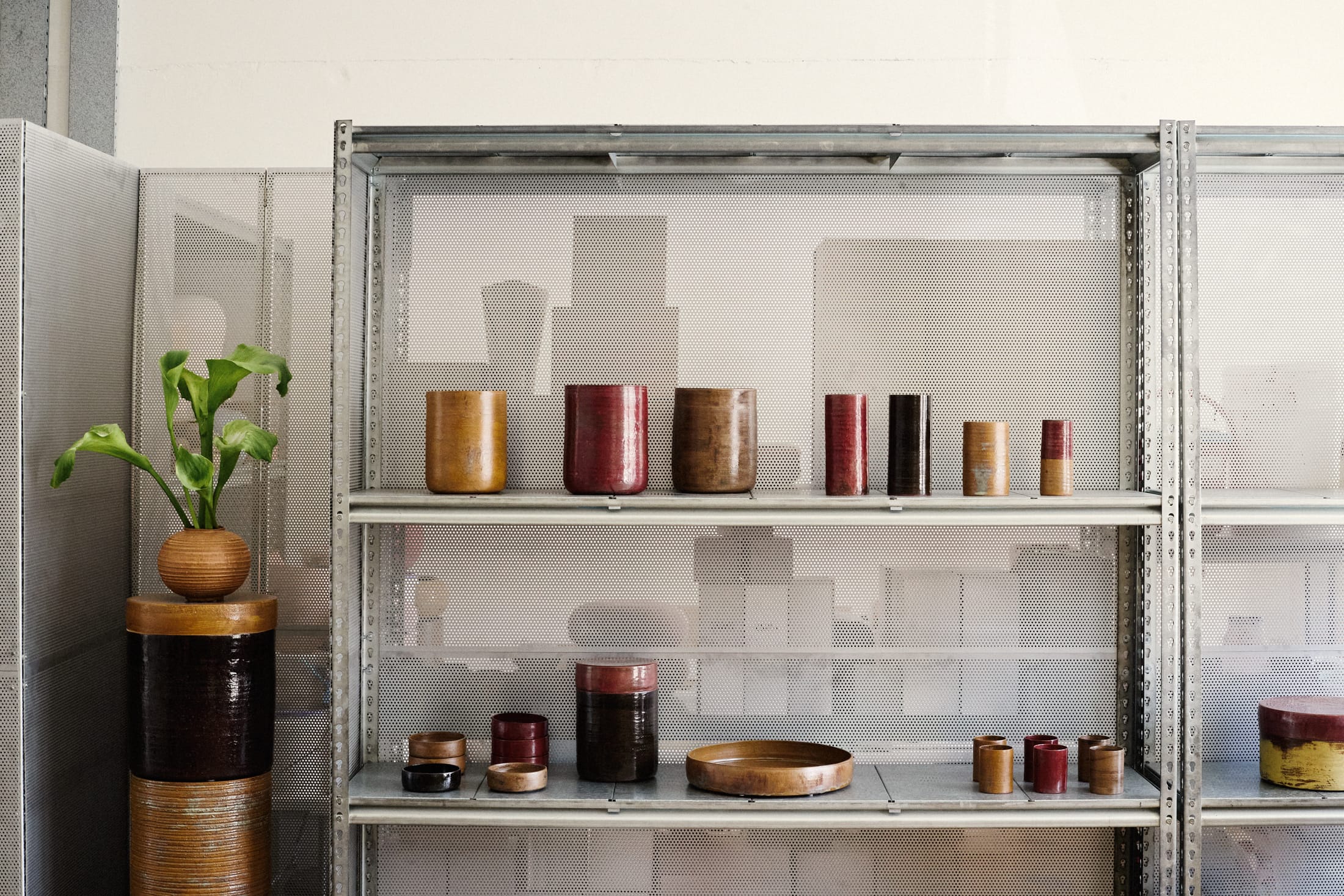 Detail of industrial metal shelving units used for archival-style display.