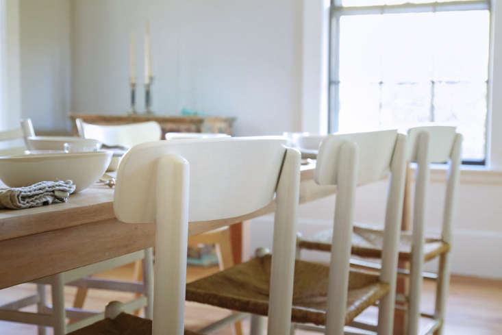 A set of four matching refurbished dining chairs styled around a table.
