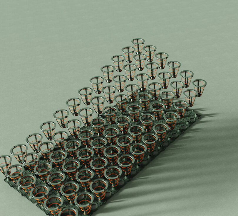 An overhead view of a matrix of metal spring coils arranged in rows on a light green surface.