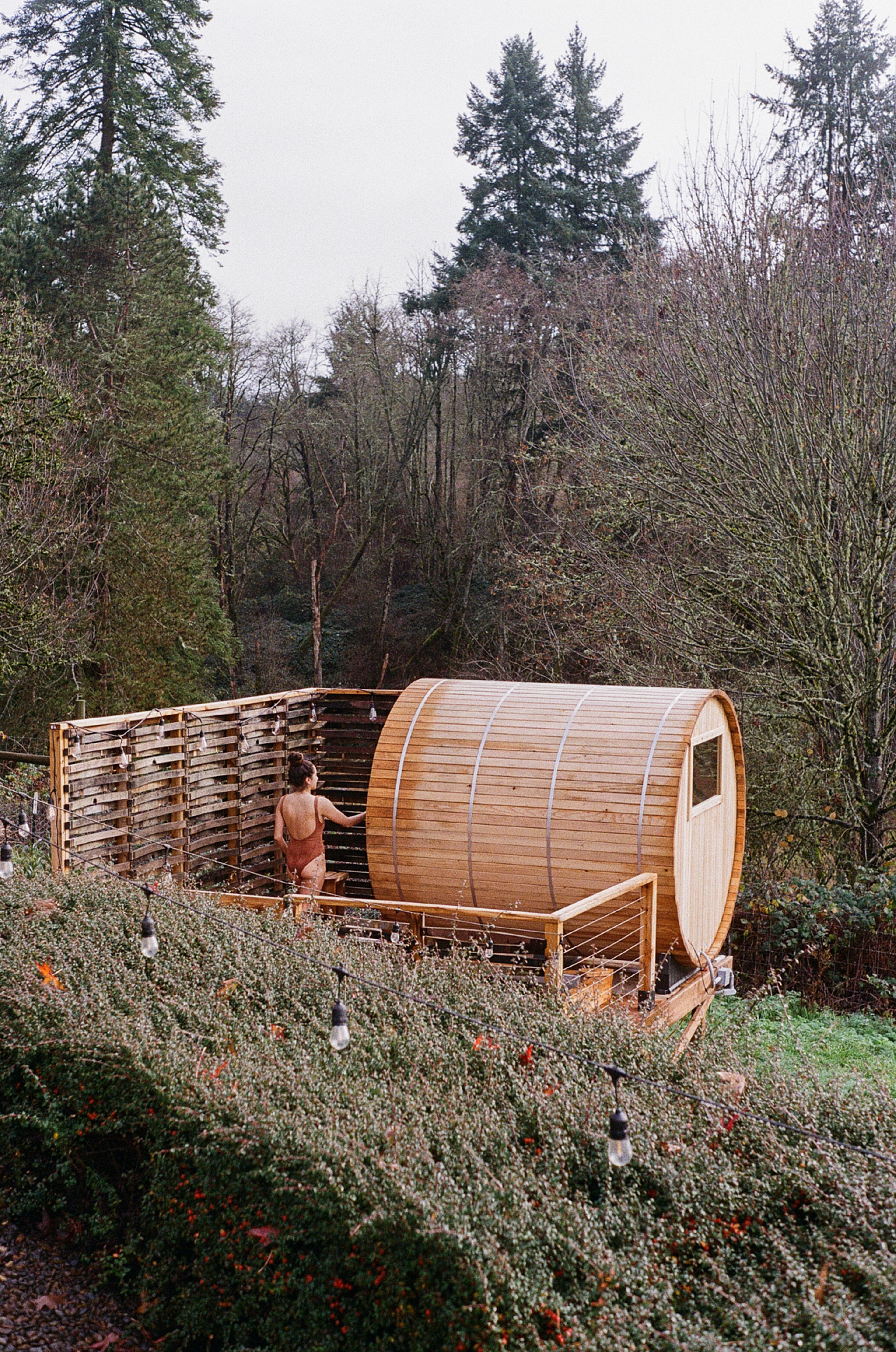 A cedar wood sauna located in the outdoor garden area of the property.