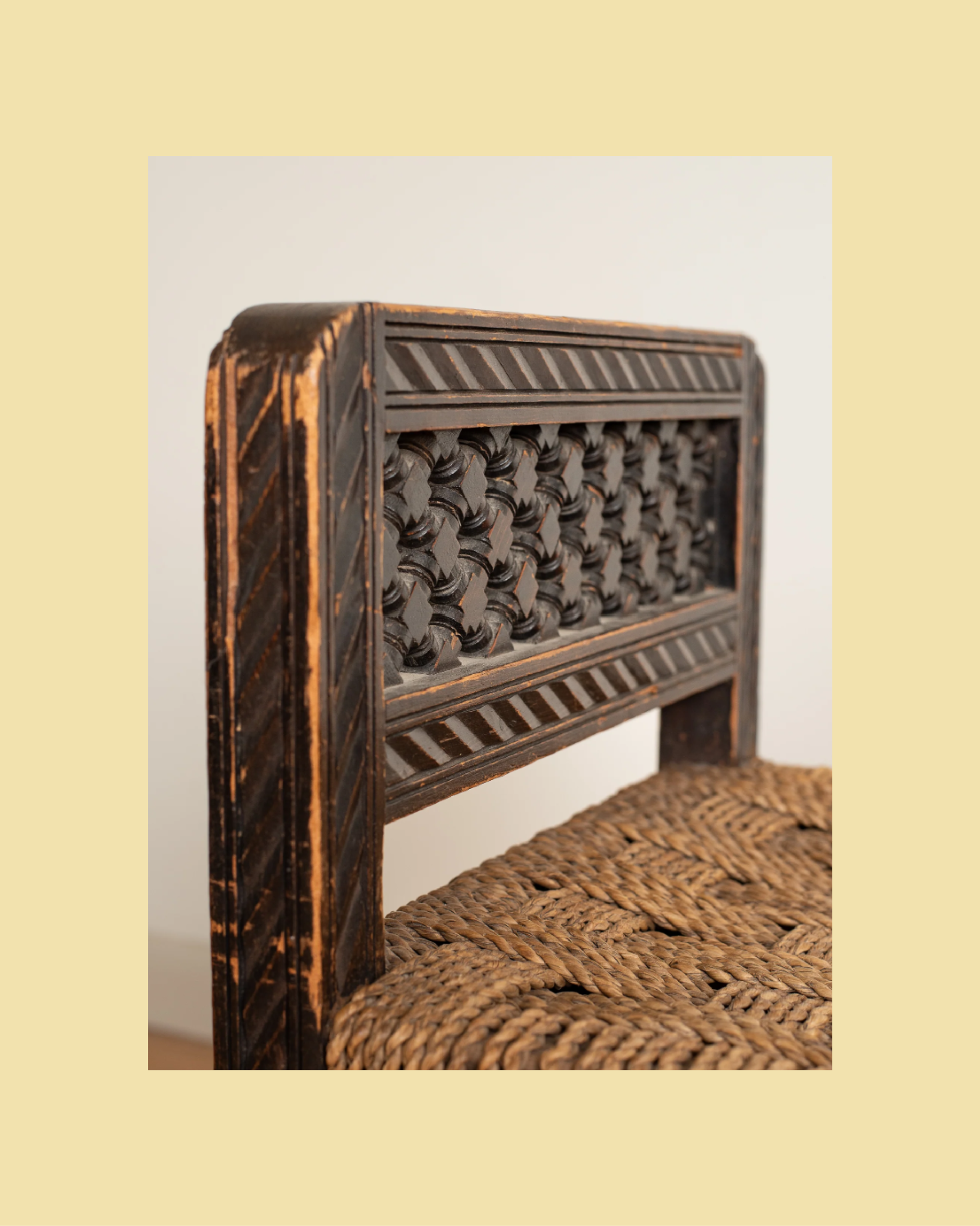 A minimalist, hand-carved wooden stool with organic, flowing lines.