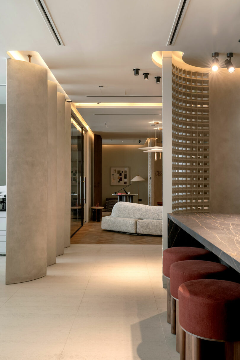 Interior view showing stone flooring, a marble bar counter, and textured wall finishes.