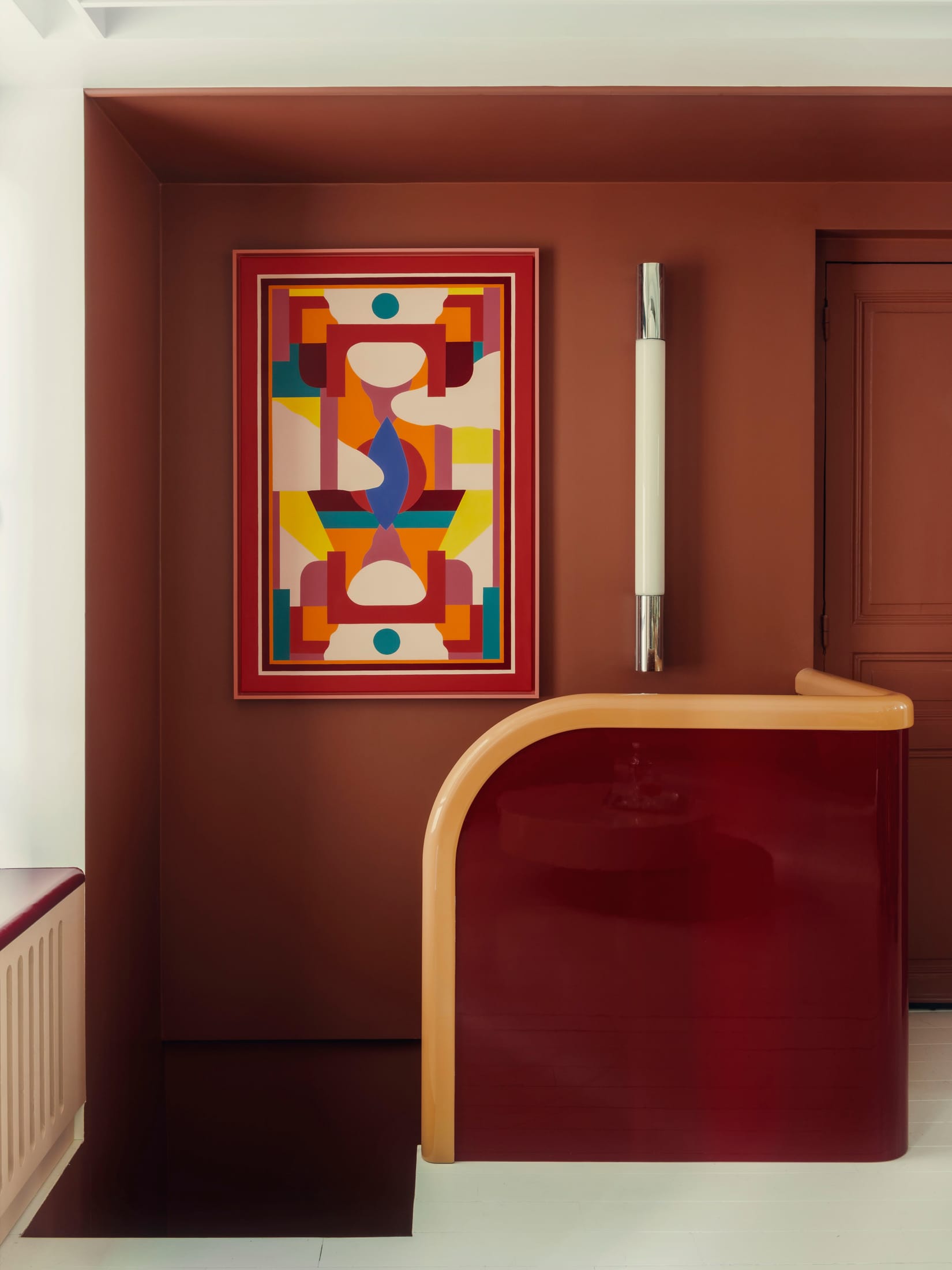 A minimalist, sculptural staircase leading to a lofted area in a high-ceilinged apartment.